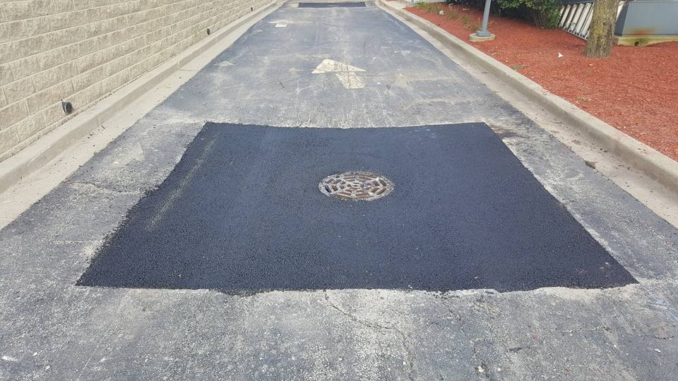 Asphalt patch repair service on damaged pavement in Missouri