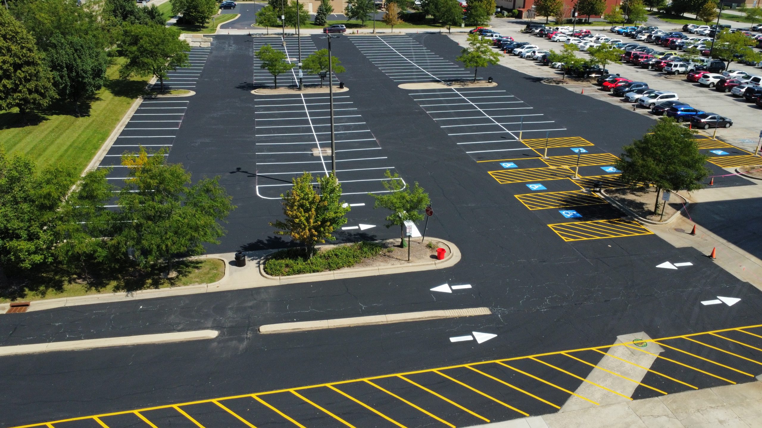 Professional asphalt pavement services in Ozark MO showing fresh parking lot line striping