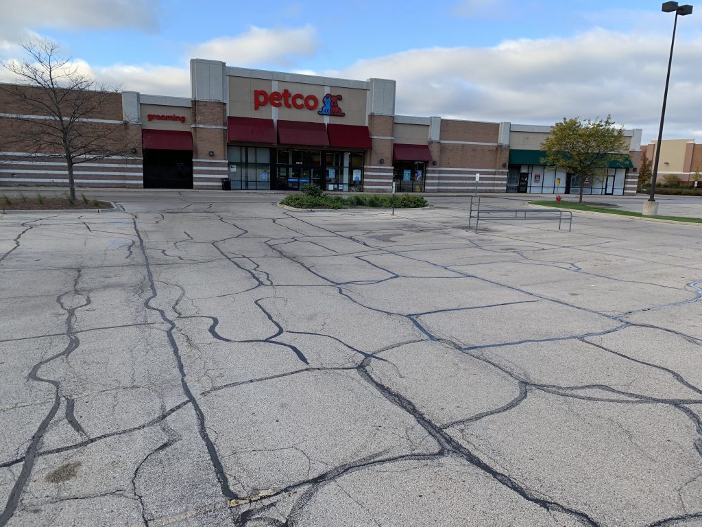 Crack sealing and sealcoating services on asphalt surface in Missouri