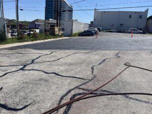 Parking lot sealcoating process