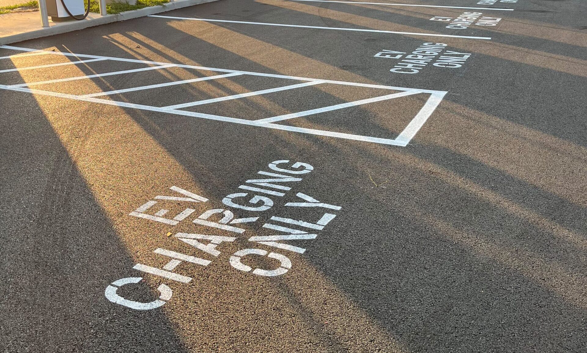 Custom EV charging only stencil and high contrast crosshatch parking line striping in Springfield MO